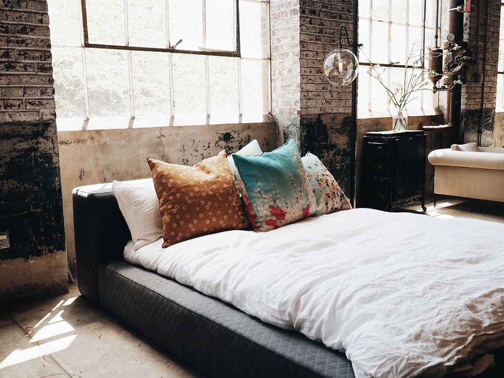 Image of a bed in a loft style apartment