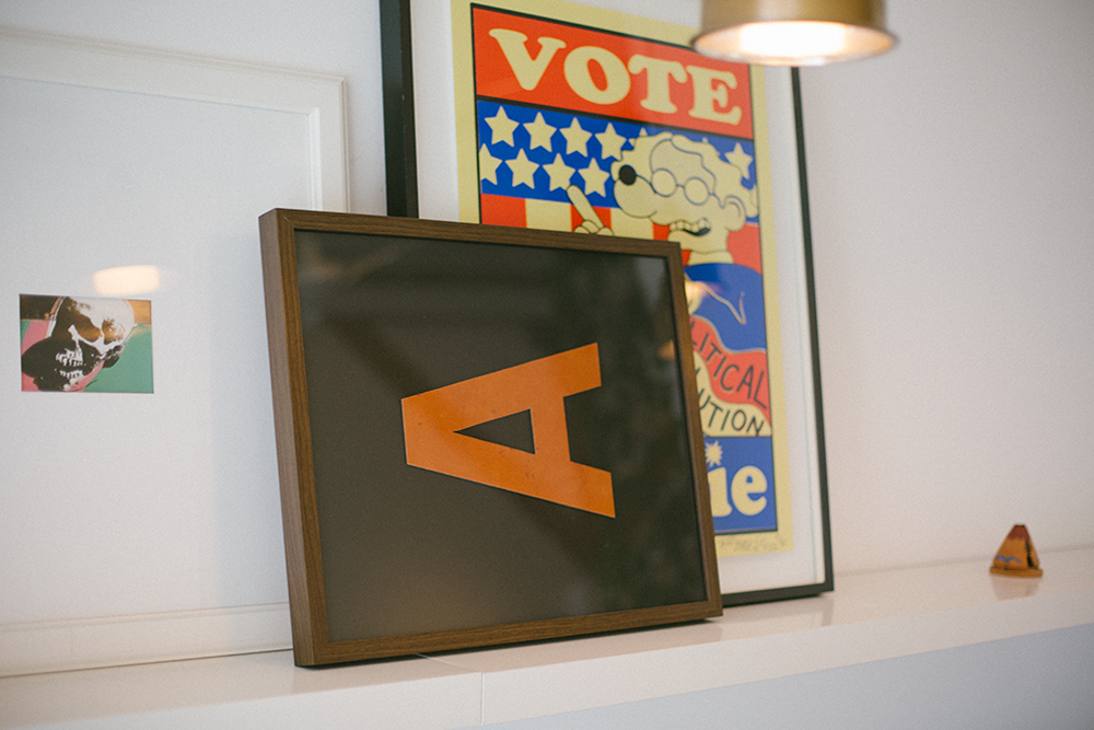 Image of typographic posters in frames leaning on mantel