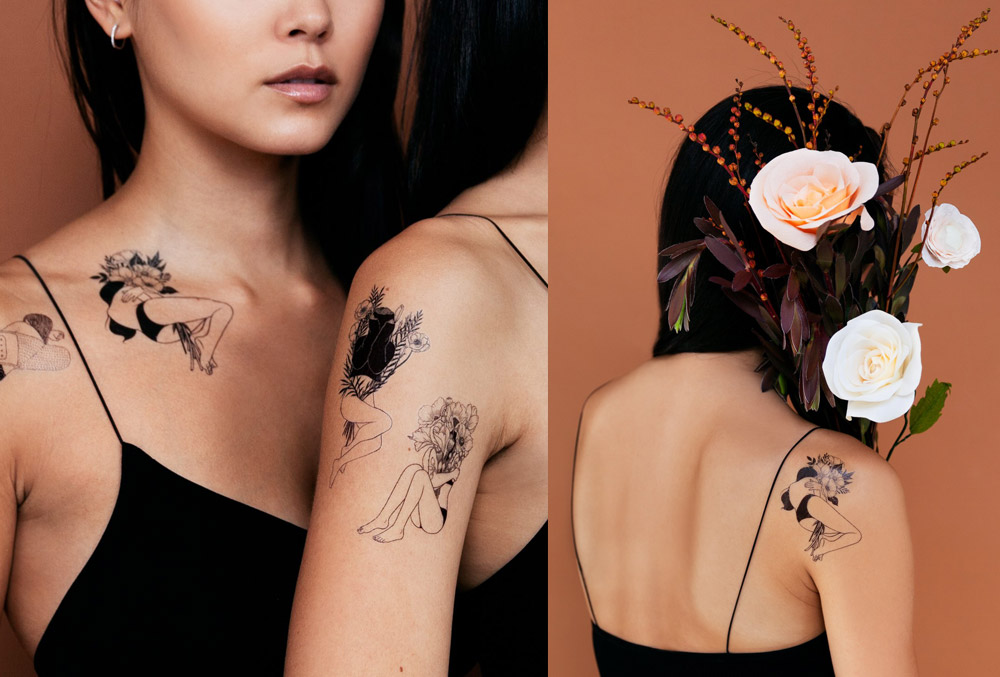 Image of two women wearing black line work Tattly tattoos surrounded by flowers
