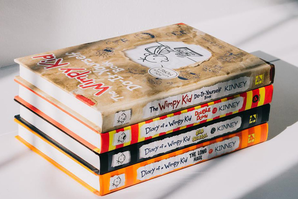 Image of 4 Wimpy Kid books stacked ontop of eachother