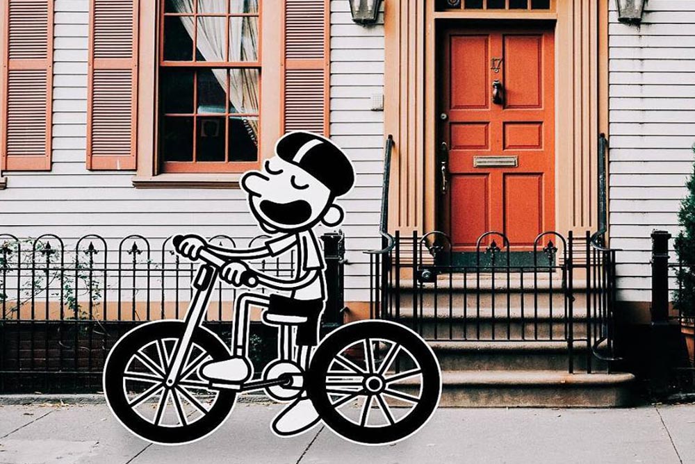 Illustration of Wimpy Kid riding a bike against the background of a house in the city
