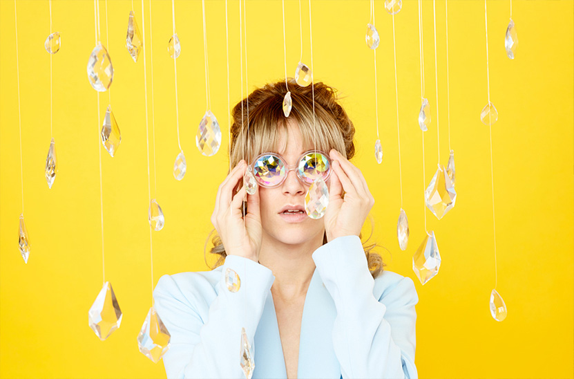 Image of model staring through eyeglasses made of crystals