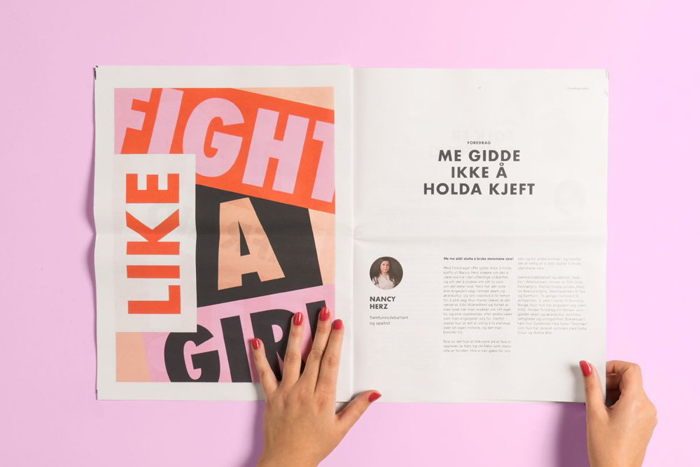 Image of a woman reading a newspaper spread saying 'Fight like a girl'