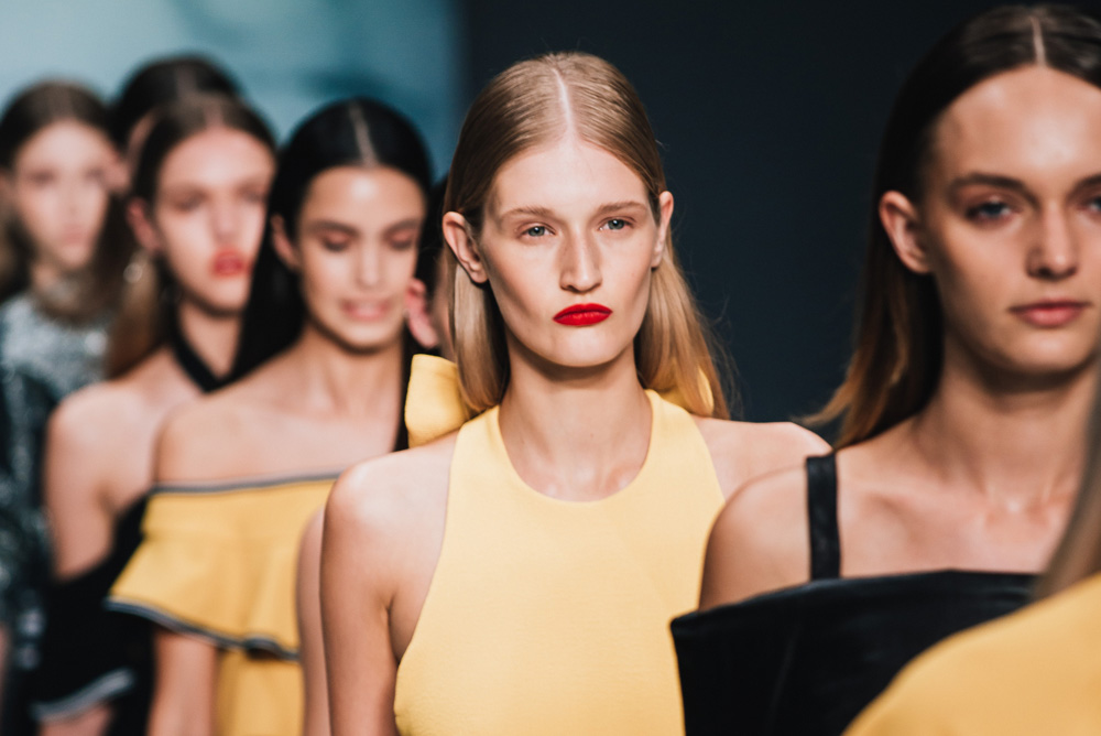 Image of models walking down catwalk