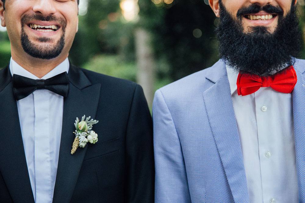 Grooms smiling at camera