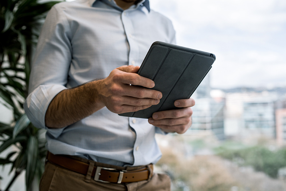 Image of a man holding an iPad