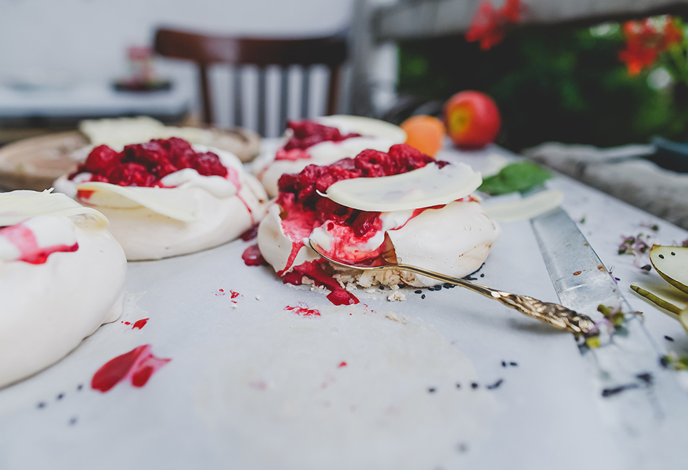 Image of pavlova covered in raspberries