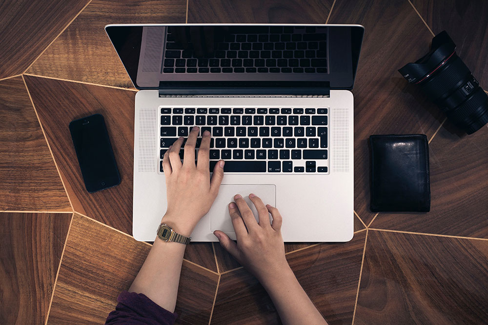 Image of a person typing on laptop