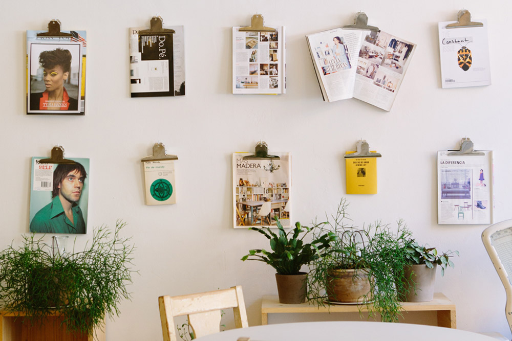 Image of magazines on a wall held up by clipboards